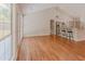 Living room with hardwood floors, an adjacent kitchen, and plenty of natural light at 4565 English Oaks Ln, Lilburn, GA 30047