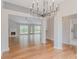 Open-concept living area with fireplace, vaulted ceilings, and abundant natural light from large windows at 4565 English Oaks Ln, Lilburn, GA 30047