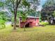 A cozy home with backyard, framed by lush trees at 551 Barnes Mill Dr, Marietta, GA 30062