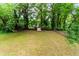 Large backyard with mature trees and a storage shed at 551 Barnes Mill Dr, Marietta, GA 30062