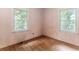 Bedroom featuring hardwood floors and bright, natural light from the windows at 551 Barnes Mill Dr, Marietta, GA 30062