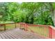 An expansive wood deck overlooks the lush, green backyard at 551 Barnes Mill Dr, Marietta, GA 30062