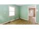 A small room with green walls and unique flooring leads to other rooms at 551 Barnes Mill Dr, Marietta, GA 30062