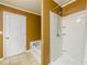 Bathroom featuring a tub and shower with tiled floors and neutral colored walls at 559 Woodland Park Ter, Lawrenceville, GA 30043