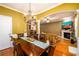 Dining room with hardwood floors and views into the living room and kitchen at 559 Woodland Park Ter, Lawrenceville, GA 30043