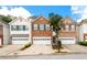Charming brick townhome featuring a one-car garage, green shutters, and well-maintained landscaping at 559 Woodland Park Ter, Lawrenceville, GA 30043