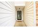 A close-up of the front door with a welcome mat, side light, and hanging light fixture at 559 Woodland Park Ter, Lawrenceville, GA 30043