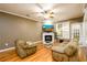 Cozy living room features hardwood floors, a fireplace, and plenty of natural light at 559 Woodland Park Ter, Lawrenceville, GA 30043