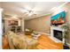 Comfortable living room features an open layout, hardwood floors, and a fireplace at 559 Woodland Park Ter, Lawrenceville, GA 30043