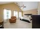 Spacious bedroom featuring a vaulted ceiling, ceiling fan, plush carpet, and windows providing natural light at 559 Woodland Park Ter, Lawrenceville, GA 30043