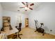 Office featuring a vaulted ceiling, ceiling fan, plush carpet, desk, shelves and exercise bicycle at 559 Woodland Park Ter, Lawrenceville, GA 30043