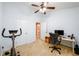 Office featuring a vaulted ceiling, ceiling fan, plush carpet, desk, and exercise bicycle at 559 Woodland Park Ter, Lawrenceville, GA 30043