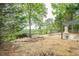 Expansive backyard boasts a wooden deck with beautiful forest views, an outdoor fireplace, and lush greenery at 861 Soaring Dr, Marietta, GA 30062