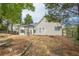 View of the backyard, featuring a covered patio, outdoor kitchen, and surrounding foliage at 861 Soaring Dr, Marietta, GA 30062