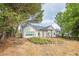 Backyard view of home with stone fire pit, outdoor seating, and screened-in porch at 861 Soaring Dr, Marietta, GA 30062