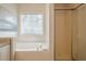 Clean and well-maintained bathroom featuring soaking tub, white tile, and glass enclosed shower at 861 Soaring Dr, Marietta, GA 30062