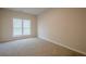 Empty bedroom with neutral walls, plush carpet, and a large window at 861 Soaring Dr, Marietta, GA 30062