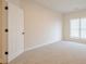 A bright bedroom features neutral carpet, fresh paint, and a window bringing in natural light at 861 Soaring Dr, Marietta, GA 30062