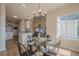 Open dining area with modern chandelier and convenient access to the kitchen and living room at 861 Soaring Dr, Marietta, GA 30062