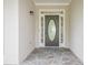 Welcoming entryway featuring a stone floor and an oval-shaped glass insert front door at 861 Soaring Dr, Marietta, GA 30062