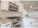 Well-lit kitchen features white cabinets, granite countertops, stainless steel appliances, and modern fixtures at 861 Soaring Dr, Marietta, GA 30062