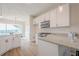Bright, modern kitchen with white cabinets, stainless appliances, and an open view to a dining area at 861 Soaring Dr, Marietta, GA 30062