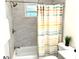 Modern bathroom features shower and tub combination with tiled surround and brushed nickel fixtures at 877 Verona Dr, Clarkston, GA 30021