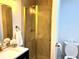 Bathroom features a modern glass-enclosed shower with gold hardware and bright vanity area at 877 Verona Dr, Clarkston, GA 30021