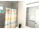 Bathroom with gray tile and a colorful shower curtain at 877 Verona Dr, Clarkston, GA 30021