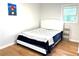 Cozy bedroom features a comfortable queen-size bed and natural light from the window at 877 Verona Dr, Clarkston, GA 30021