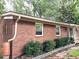 Charming brick home with manicured landscaping and a welcoming front porch at 877 Verona Dr, Clarkston, GA 30021
