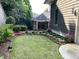 Well-maintained backyard with lush lawn, tidy flowerbeds, and privacy fence at 962 Manor Parc Dr, Decatur, GA 30033