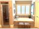 Bright bathroom featuring soaking tub, separate glass shower and tile surround at 962 Manor Parc Dr, Decatur, GA 30033