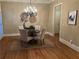Cozy dining room with elegant chandelier, round table with four chairs, and hardwood flooring at 962 Manor Parc Dr, Decatur, GA 30033