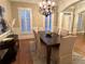 Charming dining room with a dark wood table, upholstered chairs, and natural light from shuttered windows at 962 Manor Parc Dr, Decatur, GA 30033