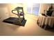 Bright exercise room featuring a treadmill, large window, and neutral color palette at 962 Manor Parc Dr, Decatur, GA 30033
