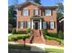 Charming brick home with black shutters, manicured landscaping, and inviting front steps at 962 Manor Parc Dr, Decatur, GA 30033