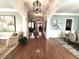 Elegant hallway with hardwood floors, decorative columns, and stylish light fixtures at 962 Manor Parc Dr, Decatur, GA 30033
