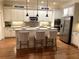 Bright and modern kitchen featuring an island with seating, stainless steel appliances, and granite countertops at 962 Manor Parc Dr, Decatur, GA 30033