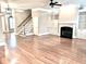 Spacious living room with hardwood floors, a fireplace, and built-in cabinets, offering an open and inviting atmosphere at 962 Manor Parc Dr, Decatur, GA 30033