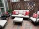 Cozy brick patio with comfortable seating and decorative red pillows, perfect for relaxing at 962 Manor Parc Dr, Decatur, GA 30033
