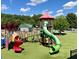 Community playground featuring a variety of colorful slides, climbing structures, and soft turf at 962 Manor Parc Dr, Decatur, GA 30033