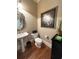 Stylish powder room with a pedestal sink, ornate mirror, and decorative accents, offering a touch of elegance at 962 Manor Parc Dr, Decatur, GA 30033