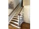 Classic staircase with wooden steps, white risers, and a stained handrail, adding character and charm to the home at 962 Manor Parc Dr, Decatur, GA 30033