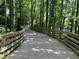Scenic wooded walking trail featuring a wooden boardwalk and lush green foliage at 962 Manor Parc Dr, Decatur, GA 30033