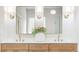 Bathroom with dual sinks, wood cabinets, quartz countertop, and decorative lighting at 1826 Terry Mill Se Rd, Atlanta, GA 30316