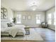 Spacious bedroom with large windows, chandelier, neutral walls and wood-look floors at 1826 Terry Mill Se Rd, Atlanta, GA 30316