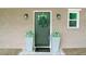 Stylish front door with wreath, gray planters, and a 'hello' welcome mat at 1826 Terry Mill Se Rd, Atlanta, GA 30316