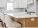 Eat-in kitchen with quartz countertop, white shaker cabinets, and modern light fixtures at 1826 Terry Mill Se Rd, Atlanta, GA 30316
