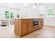 Kitchen island with breakfast bar seating, stainless appliances, and wooden cabinets at 1826 Terry Mill Se Rd, Atlanta, GA 30316